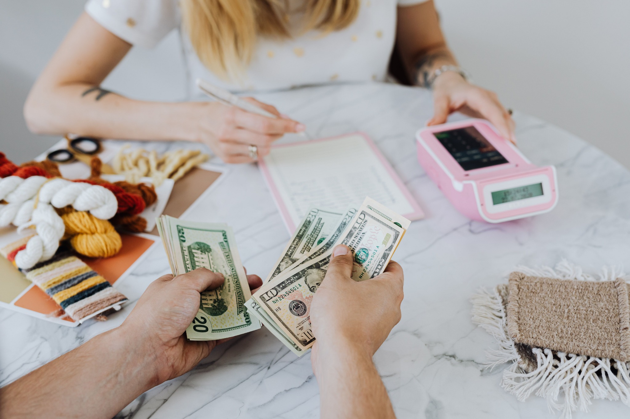 Person planning a budget while counting cash